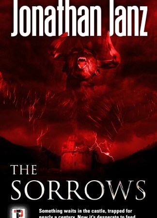 All is red and black. A castle sits in front of a red sky as a demonic figure appears in the sky above. Text: "Jonathan Janz. The Sorrows. Something waits in the castle, trapped for nearly a century. Now it's desperate to feed."